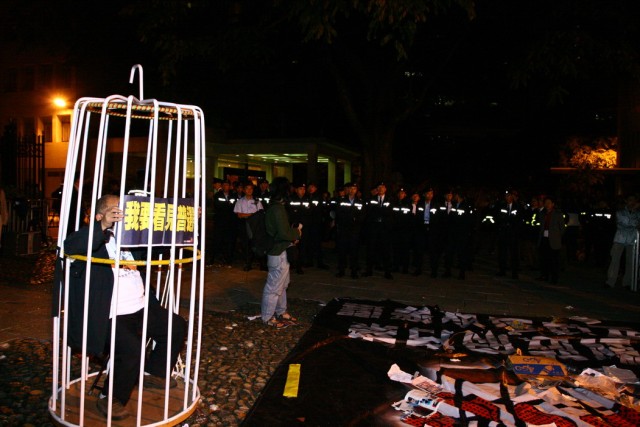a protestor in a cage